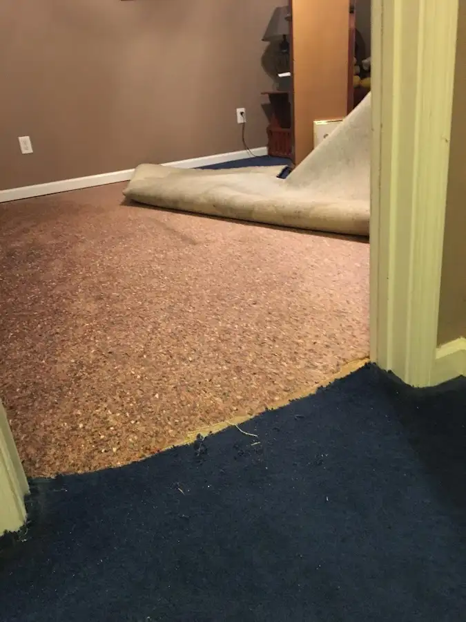 Carpet pad removal revealing water damage during Water Mitigation Services in Saranap